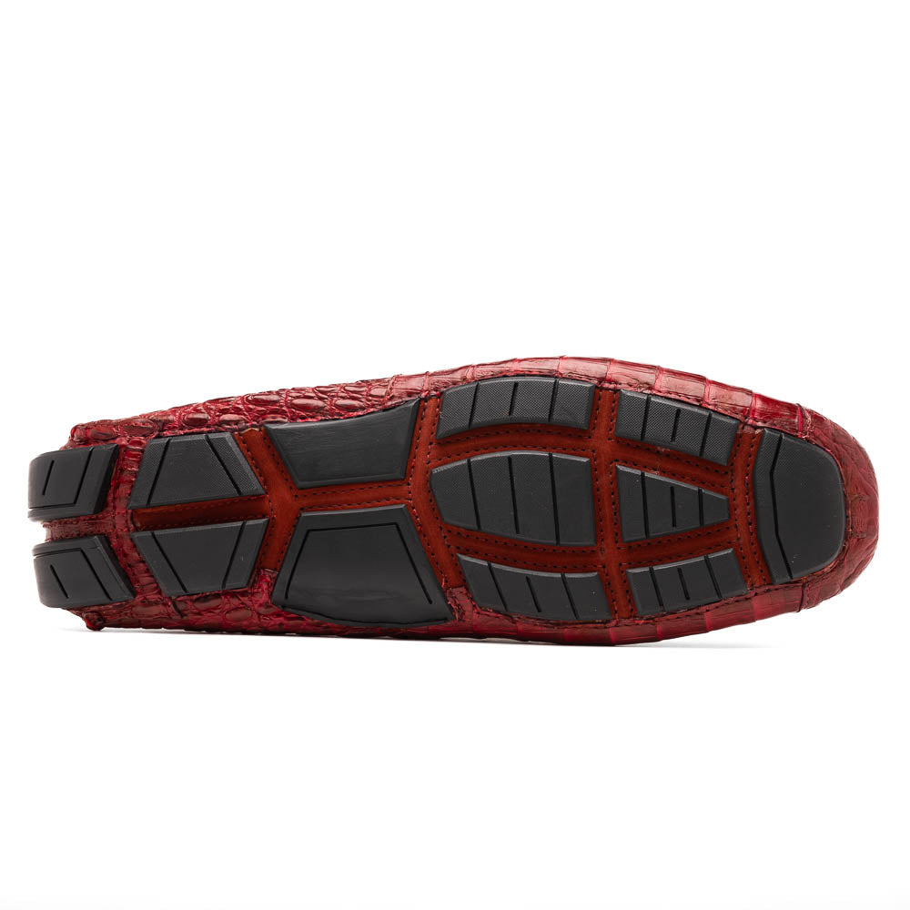 The Marco Di Milano Remo Wine features red crocodile-pattern leather driving shoes: one upright, one on its side showing a black rubber sole with red highlights—ideal for luxury men's footwear enthusiasts.