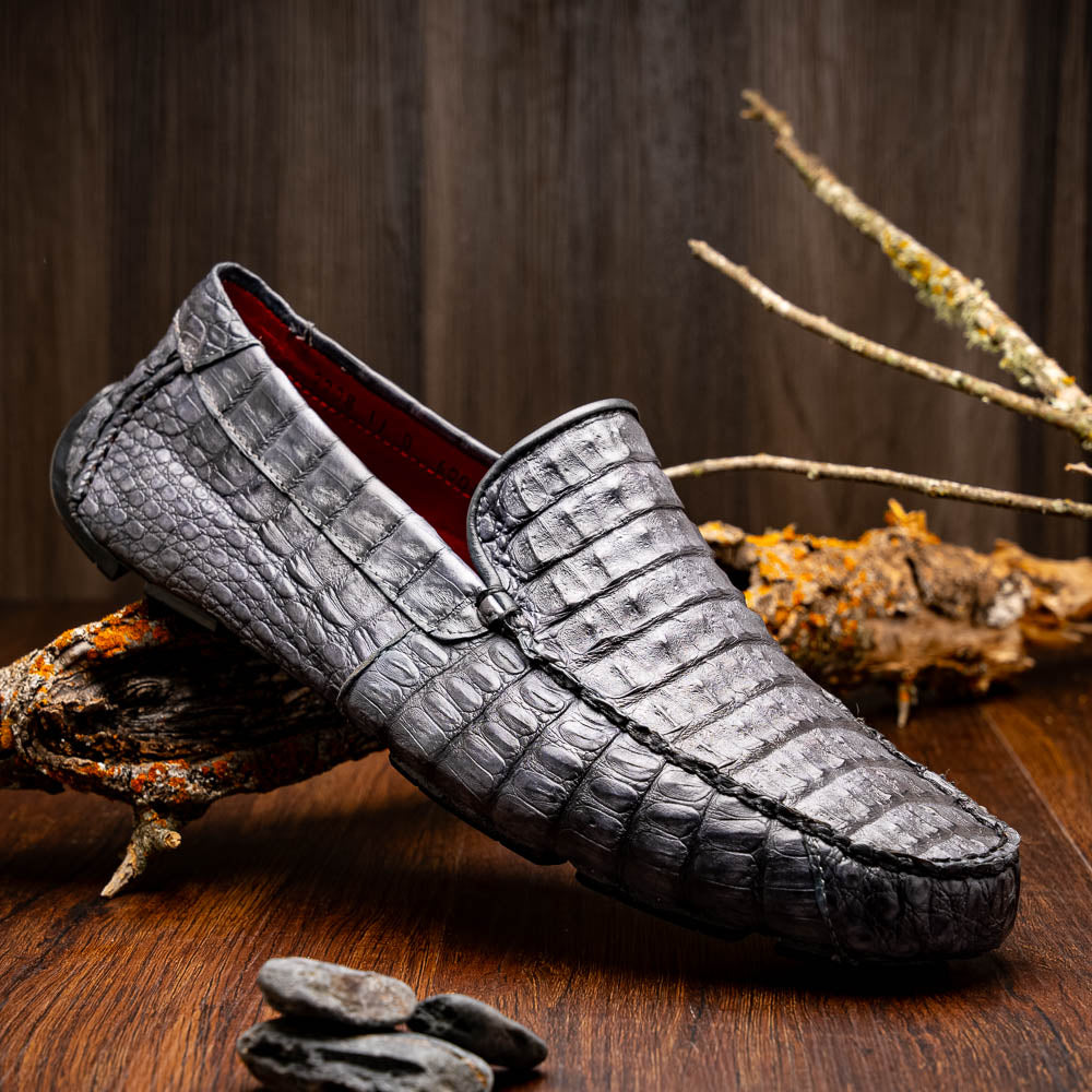 The Remo Gray driving loafers by Marco Di Milano feature a textured gray upper and rubber sole, with one shoe upright and the other leaning—ideal for genuine exotic footwear enthusiasts.