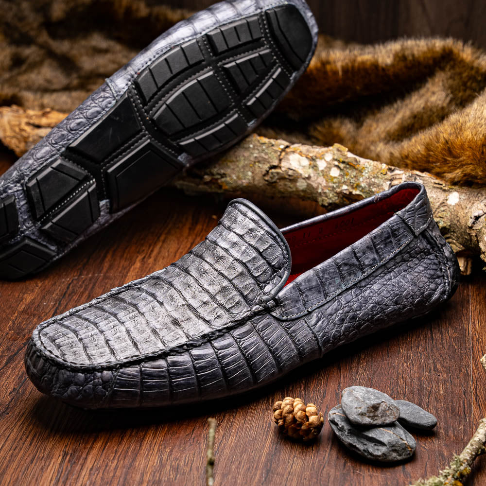 The Remo Gray driving loafers by Marco Di Milano feature a textured gray upper and rubber sole, with one shoe upright and the other leaning—ideal for genuine exotic footwear enthusiasts.