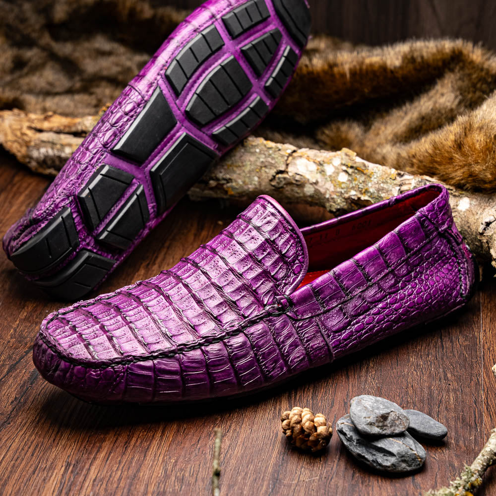 The Remo Purple by Marco Di Milano: a pair of crocodile-patterned purple leather driving loafers, one upright and one on its side revealing the black rubber sole—luxury men's footwear at its finest.