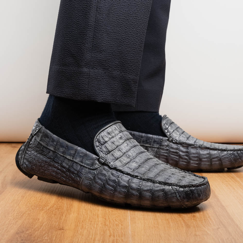 The Remo Gray driving loafers by Marco Di Milano feature a textured gray upper and rubber sole, with one shoe upright and the other leaning—ideal for genuine exotic footwear enthusiasts.