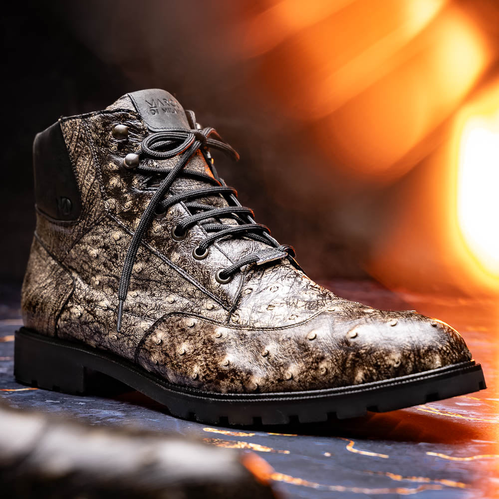 The Renzo Stone Black boots by Marco Di Milano feature genuine ostrich leather in brown, black laces, and black rubber soles—luxury footwear with a unique exotic flair.