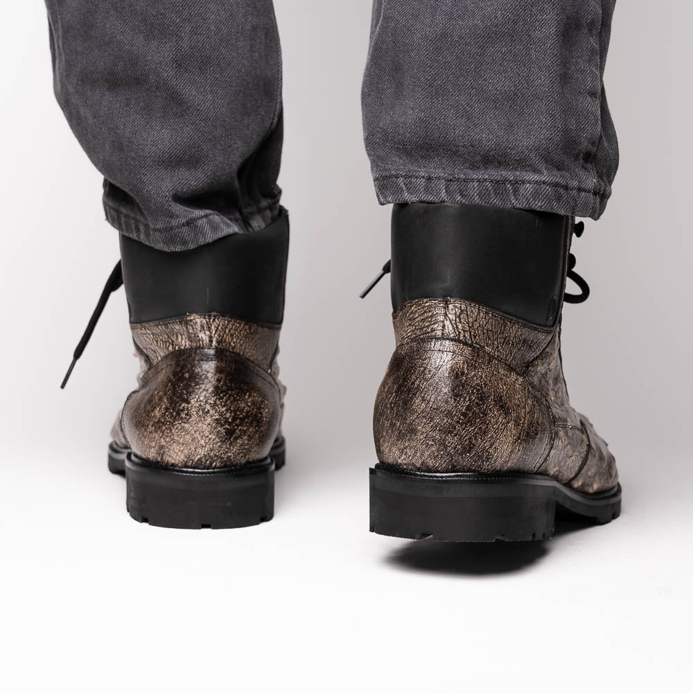 The Renzo Stone Black boots by Marco Di Milano feature genuine ostrich leather in brown, black laces, and black rubber soles—luxury footwear with a unique exotic flair.