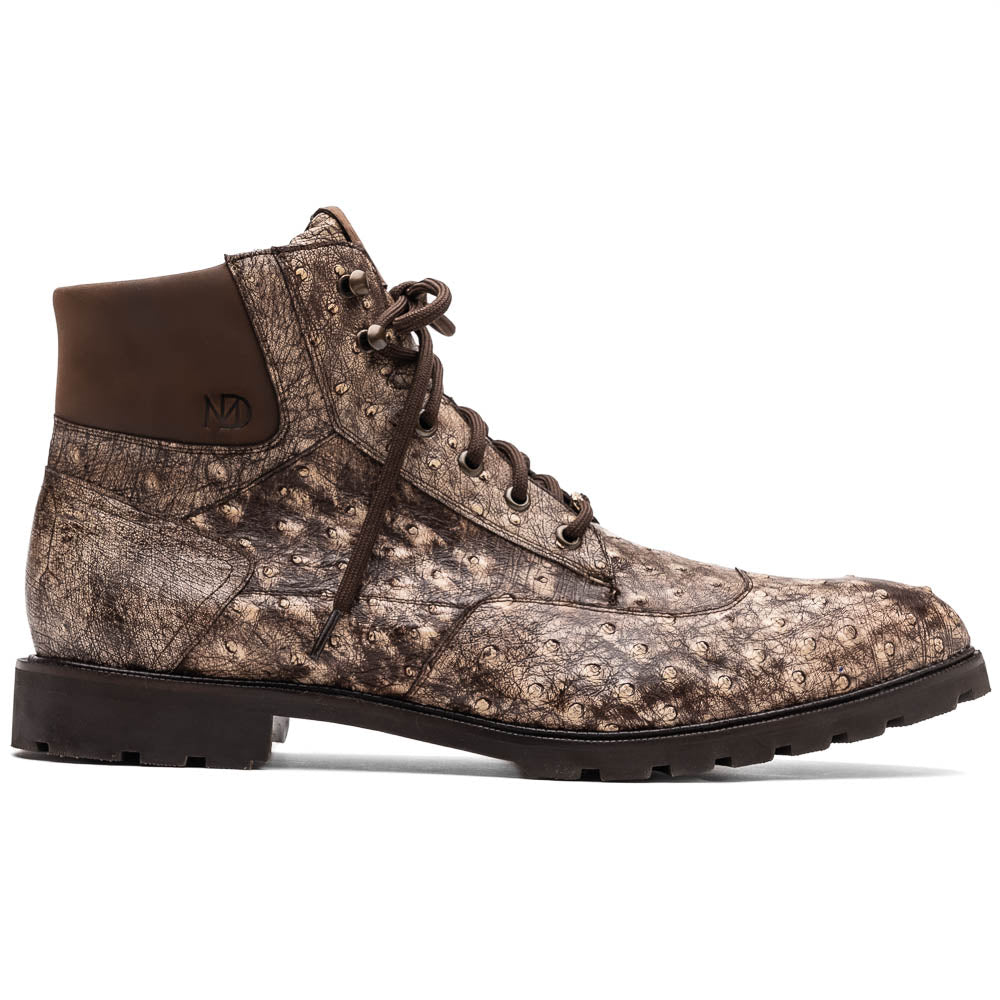 The Renzo Stone Brown by Marco Di Milano are lace-up ankle boots featuring a textured, speckled pattern and thick black rubber soles—one stands upright while the other lies on its side—ideal for luxury footwear lovers.