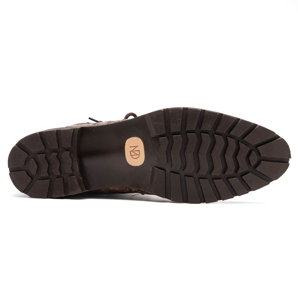 The Renzo Stone Brown by Marco Di Milano are lace-up ankle boots featuring a textured, speckled pattern and thick black rubber soles—one stands upright while the other lies on its side—ideal for luxury footwear lovers.