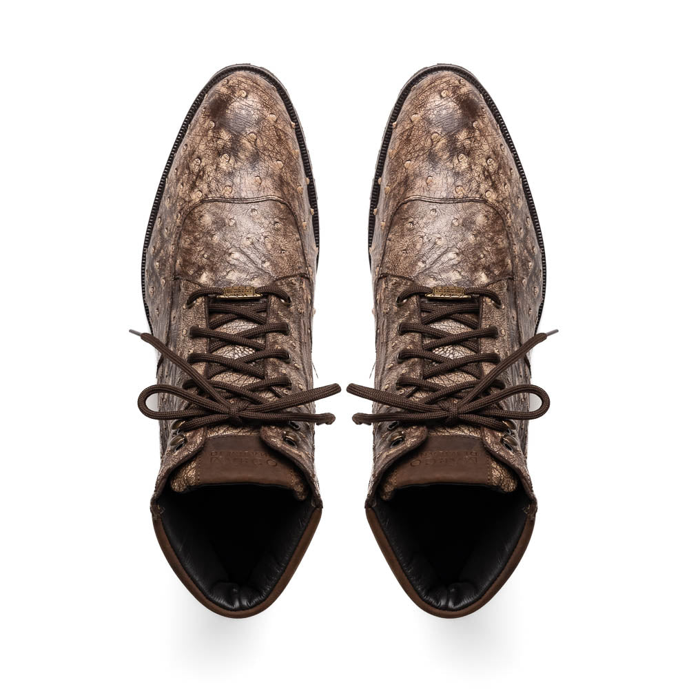 The Renzo Stone Brown by Marco Di Milano are lace-up ankle boots featuring a textured, speckled pattern and thick black rubber soles—one stands upright while the other lies on its side—ideal for luxury footwear lovers.