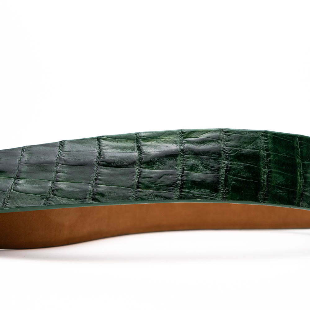 The Riccardo Belt Forest Green by Marco Di Milano features crocodile-embossed dark green leather and a silver buckle engraved with the brand logo, displayed coiled on a white background.