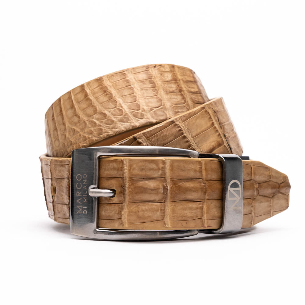 The Riccardo Belt Oil Orix by Marco Di Milano features genuine exotic leather with a crocodile pattern, a silver engraved buckle, and brand logos—elegantly coiled on a white background.