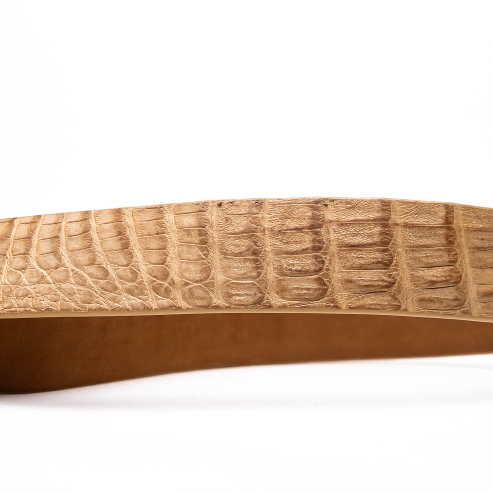 The Riccardo Belt Oil Orix by Marco Di Milano features genuine exotic leather with a crocodile pattern, a silver engraved buckle, and brand logos—elegantly coiled on a white background.