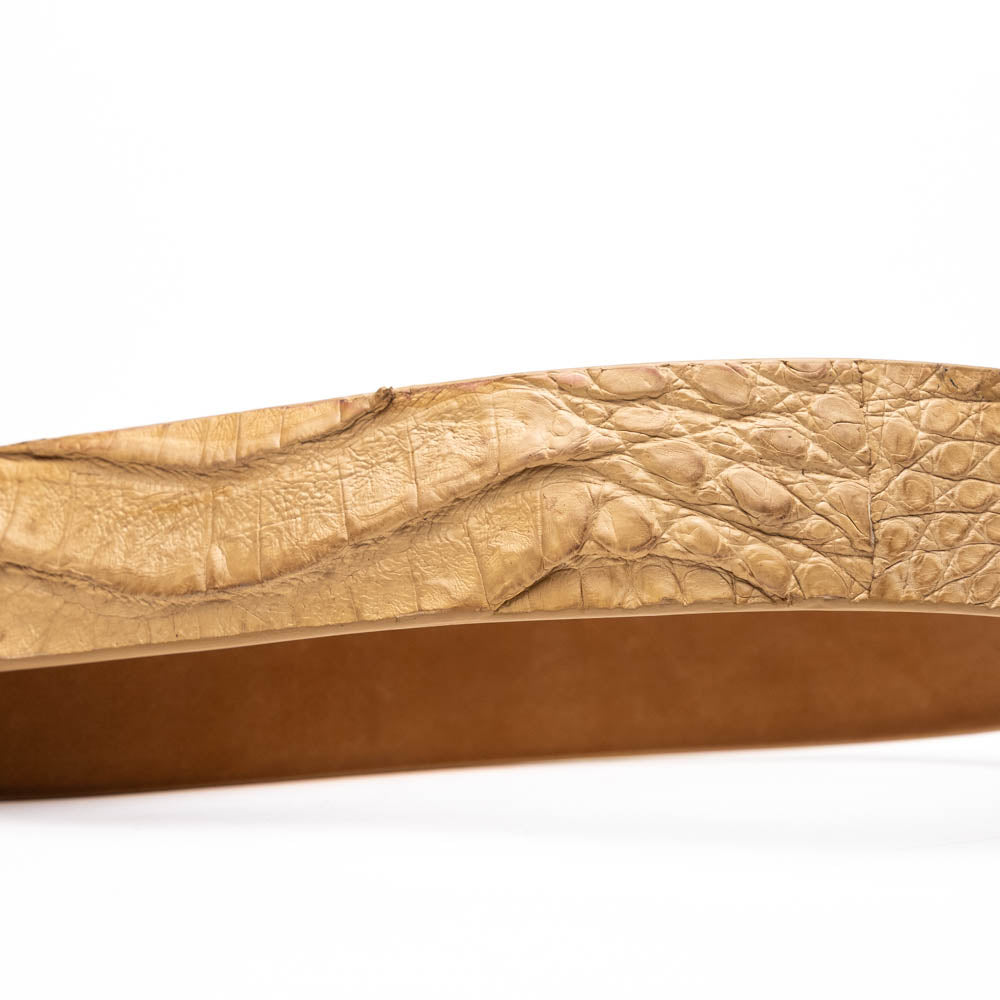 The Riccardo Belt Orix by Marco Di Milano is a rolled tan caiman fuscus-belly belt with an engraved silver buckle, shown on a white background—a genuine exotic accessory.