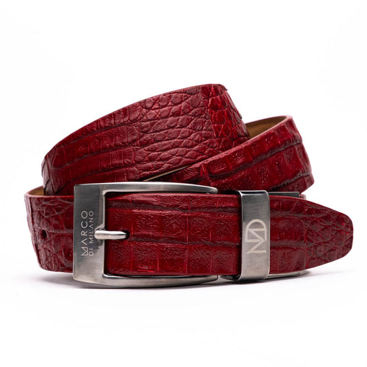 The Riccardo Belt Red by Marco Di Milano, crafted from genuine caiman fuscus-belly leather with a crocodile texture and a silver engraved buckle, is elegantly displayed coiled on a white background—perfect for refined style.