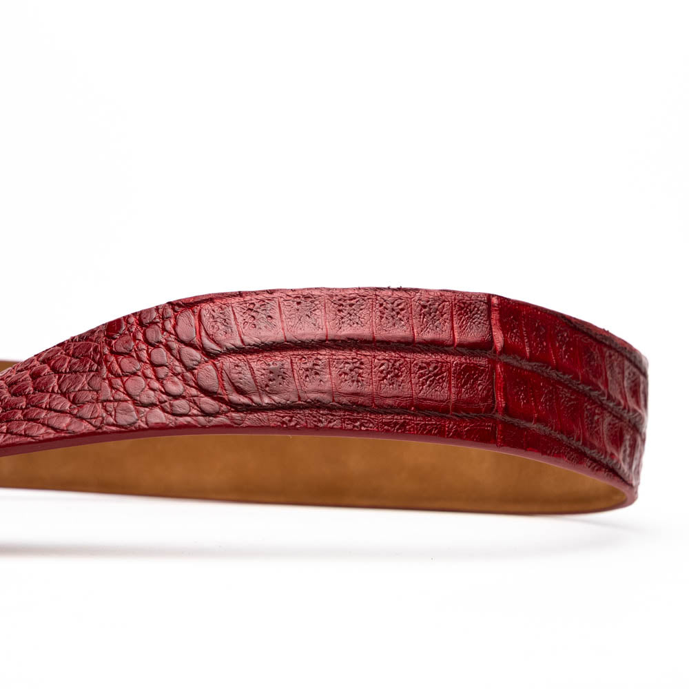 The Riccardo Belt Red by Marco Di Milano, crafted from genuine caiman fuscus-belly leather with a crocodile texture and a silver engraved buckle, is elegantly displayed coiled on a white background—perfect for refined style.