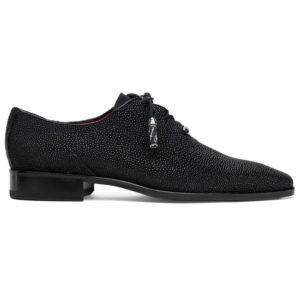 A pair of Rimini Black luxury dress shoes by Marco Di Milano, featuring a black textured finish and lace-up closure—one shoe displayed upright while the other shows the brown leather sole with embossed branding.