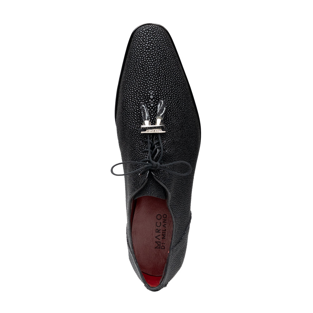 A pair of Rimini Black luxury dress shoes by Marco Di Milano, featuring a black textured finish and lace-up closure—one shoe displayed upright while the other shows the brown leather sole with embossed branding.