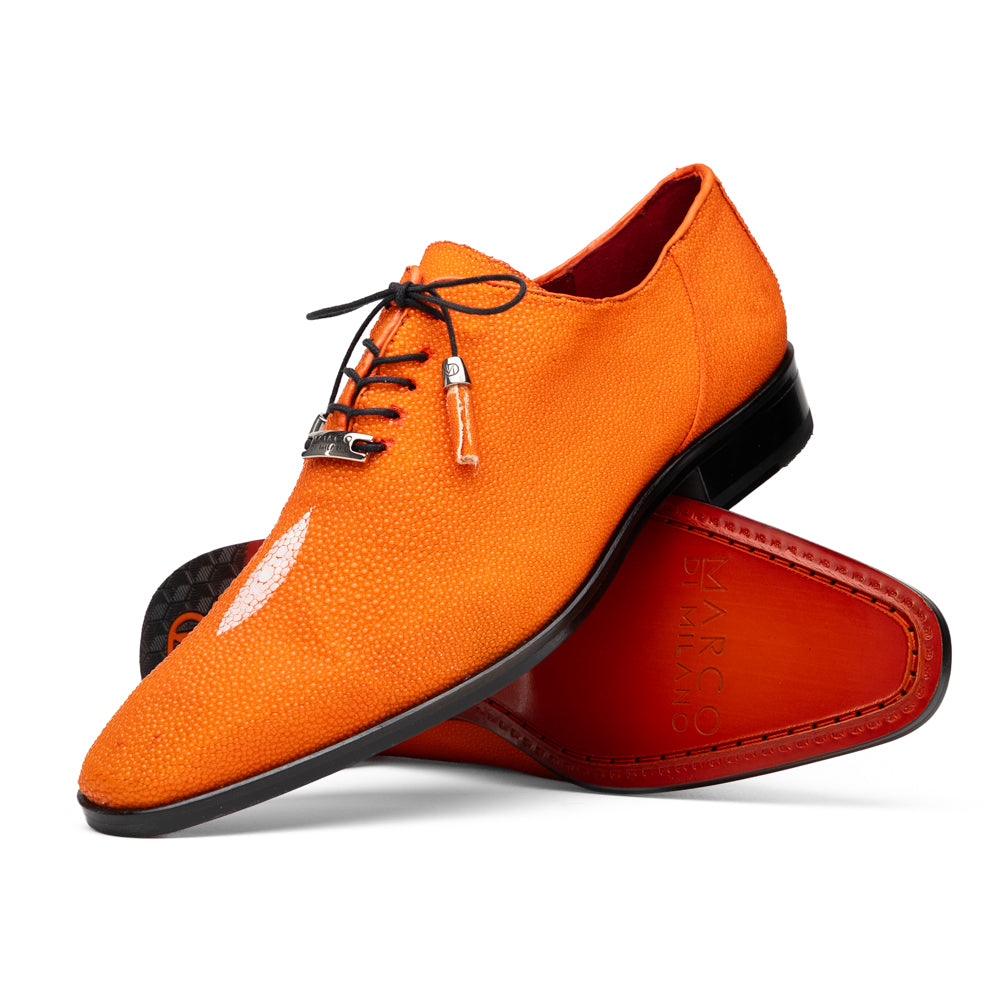Rimini Orange men’s exotic lace-up dress shoes by Marco Di Milano, expertly crafted from genuine stingray leather in a bright orange hue with black laces; one shoe stands upright while the other lies on its side, showcasing the vibrant red sole and contrasting black heel.