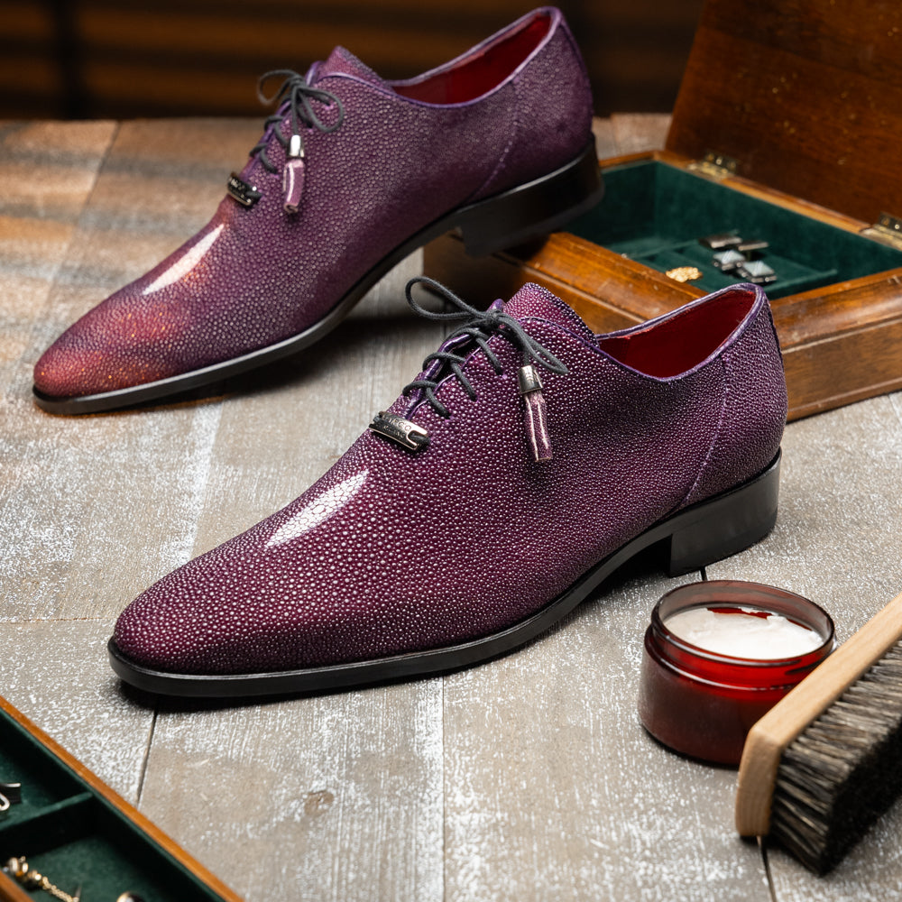 The Rimini Purple by Marco Di Milano is a single purple textured exotic lace-up shoe with black laces, shown from above, featuring a decorative metal and crystal accessory on the tongue.