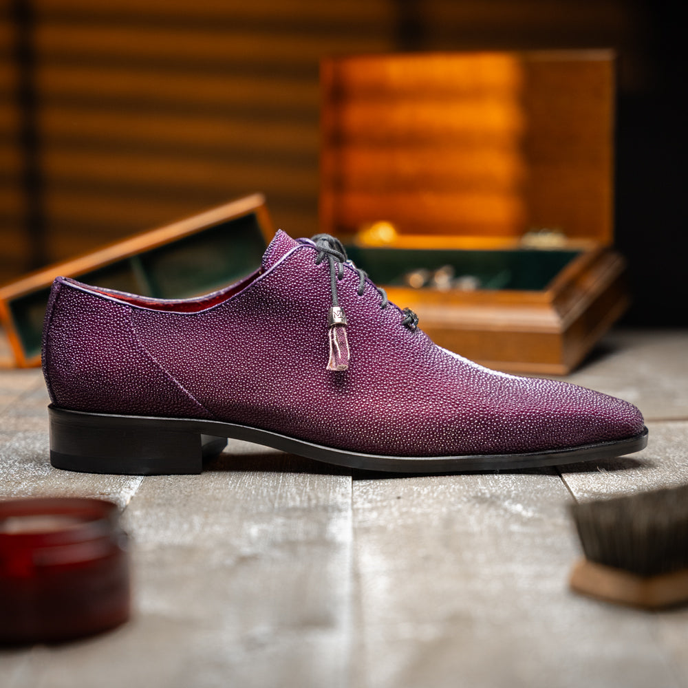 The Rimini Purple by Marco Di Milano is a single purple textured exotic lace-up shoe with black laces, shown from above, featuring a decorative metal and crystal accessory on the tongue.