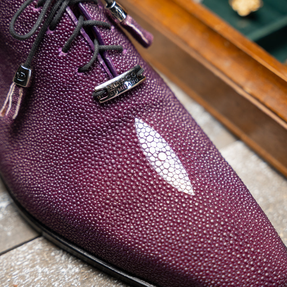 The Rimini Purple by Marco Di Milano is a single purple textured exotic lace-up shoe with black laces, shown from above, featuring a decorative metal and crystal accessory on the tongue.