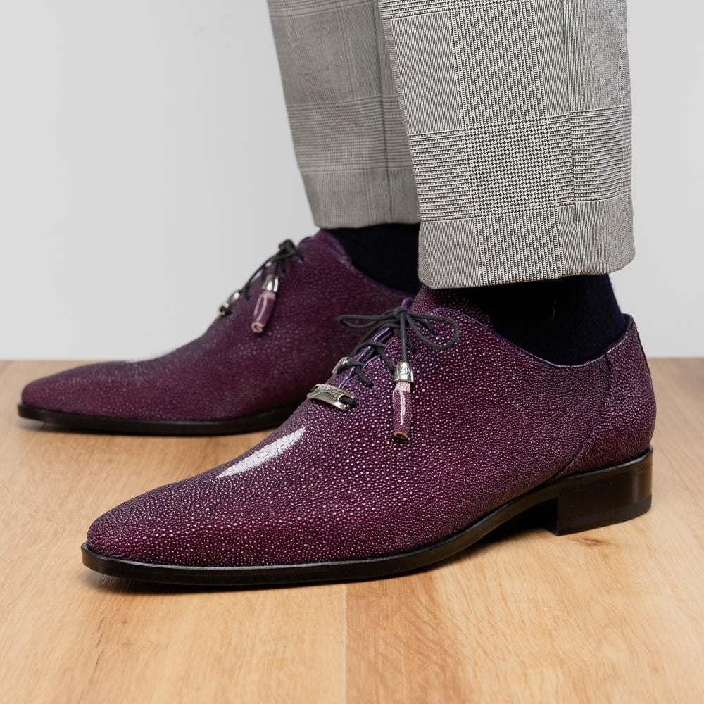 The Rimini Purple by Marco Di Milano is a single purple textured exotic lace-up shoe with black laces, shown from above, featuring a decorative metal and crystal accessory on the tongue.