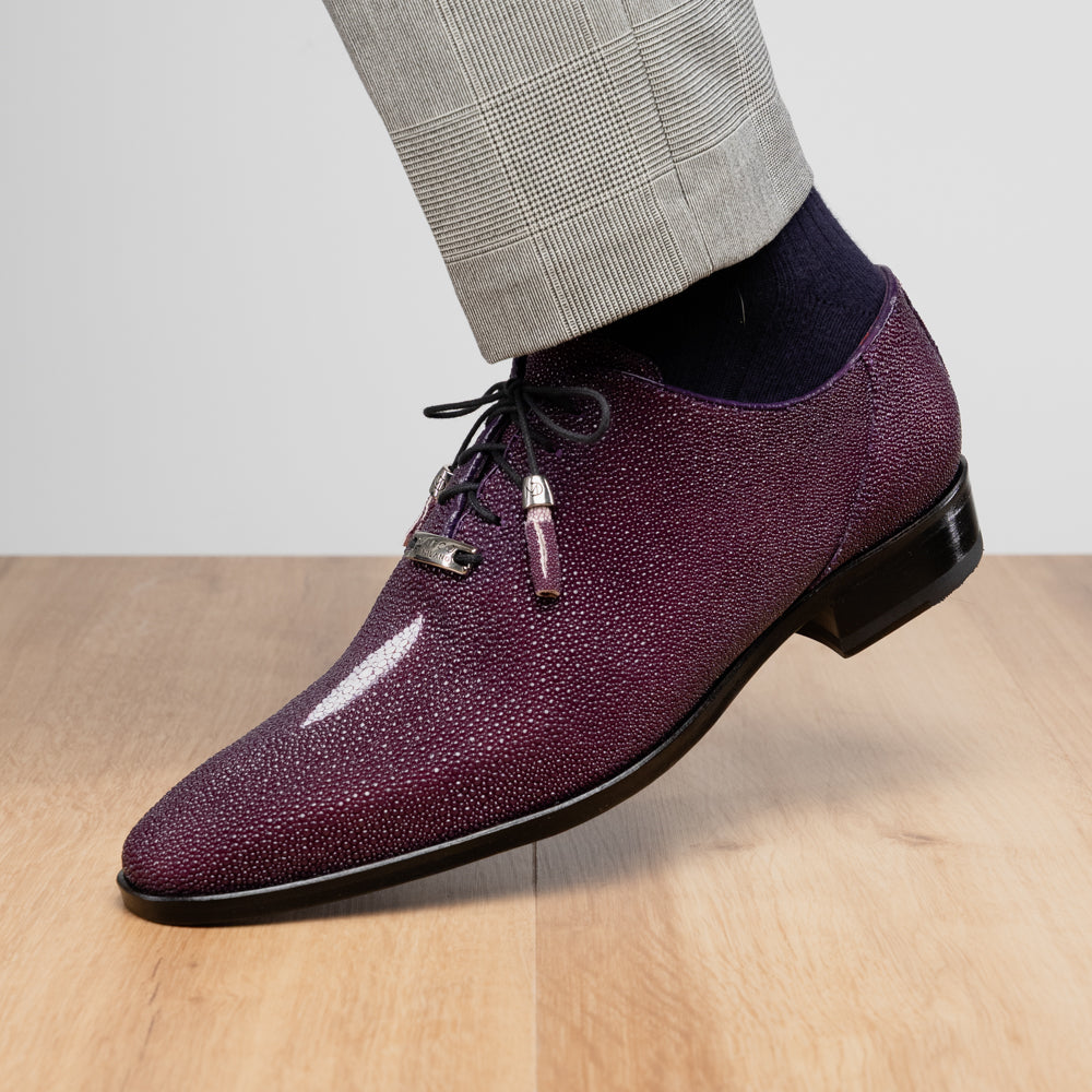 The Rimini Purple by Marco Di Milano is a single purple textured exotic lace-up shoe with black laces, shown from above, featuring a decorative metal and crystal accessory on the tongue.