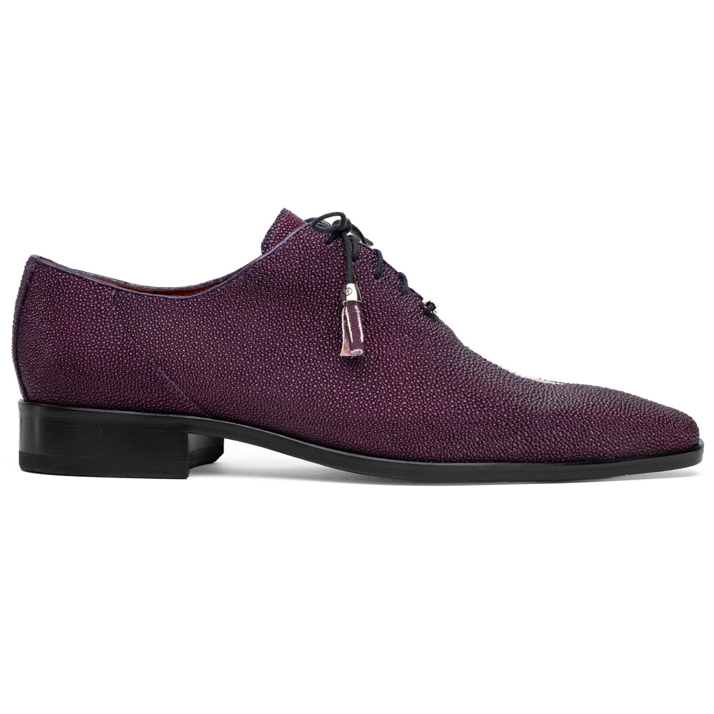 A pair of Marco Di Milano Rimini Purple textured leather dress shoes with black laces and tassel accents, featuring one shoe upright and the other on its side to showcase the bold purple sole—an eye-catching exotic lace-up design crafted to stand out.