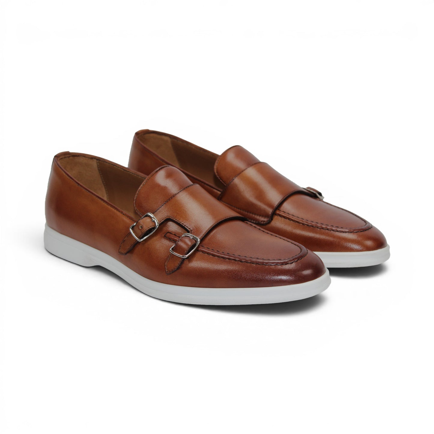 The Duca Di Matiste Duca Rimini Cognac is a brown premium calf leather loafer with metal buckle details and a white rubber sole, showcasing timeless sophistication in its side profile against a plain white background.