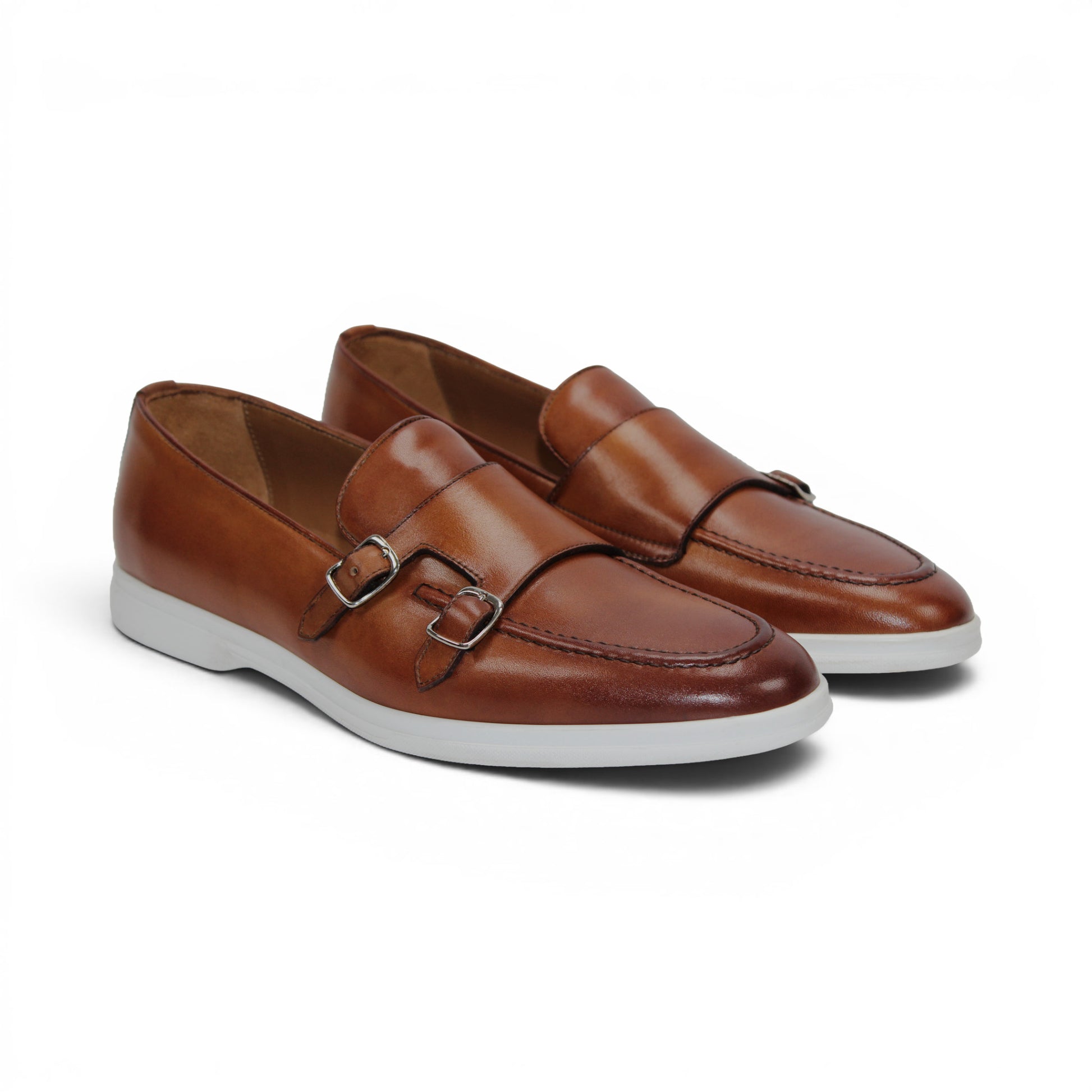 The Duca Di Matiste Duca Rimini Cognac is a brown premium calf leather loafer with metal buckle details and a white rubber sole, showcasing timeless sophistication in its side profile against a plain white background.