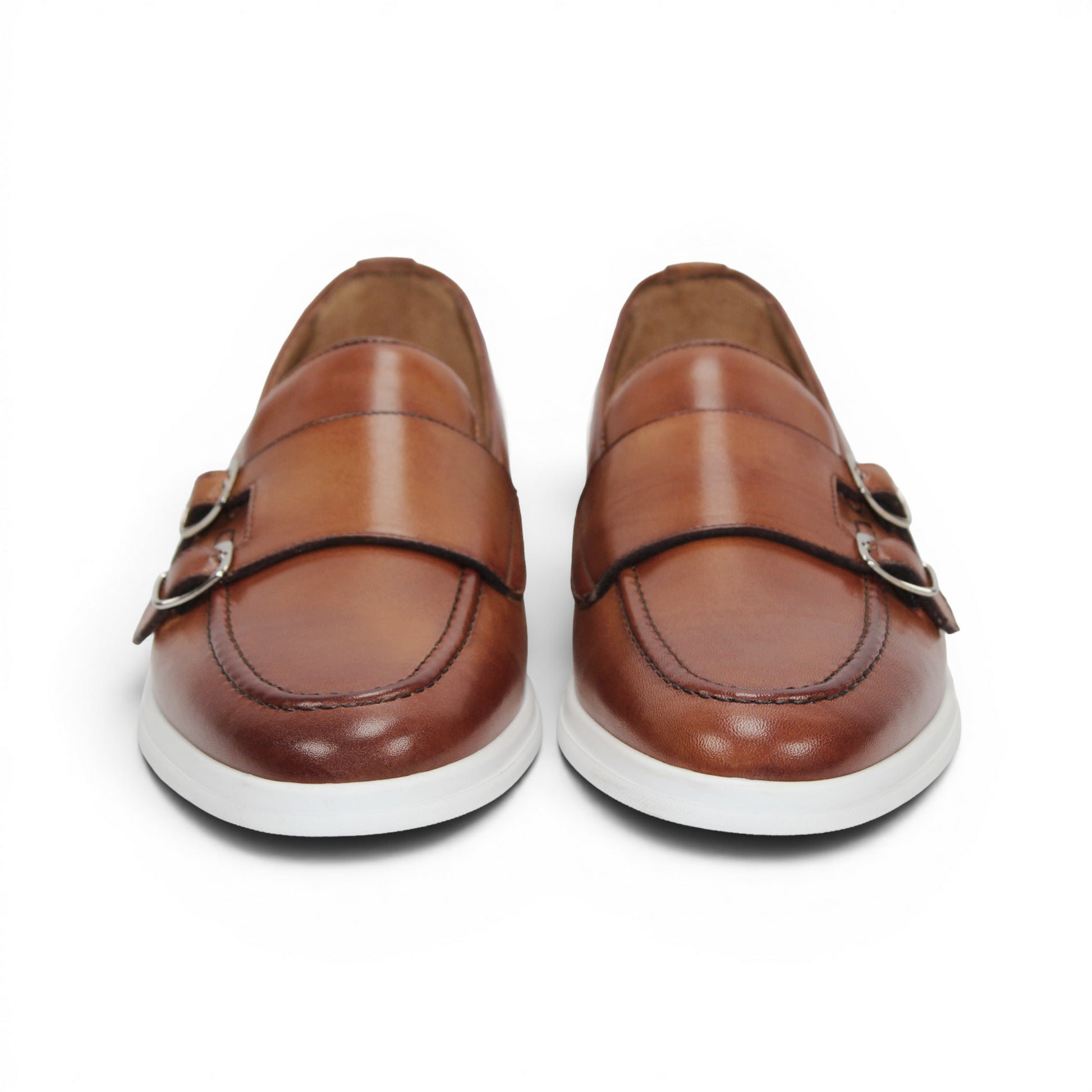 The Duca Di Matiste Duca Rimini Cognac is a brown premium calf leather loafer with metal buckle details and a white rubber sole, showcasing timeless sophistication in its side profile against a plain white background.