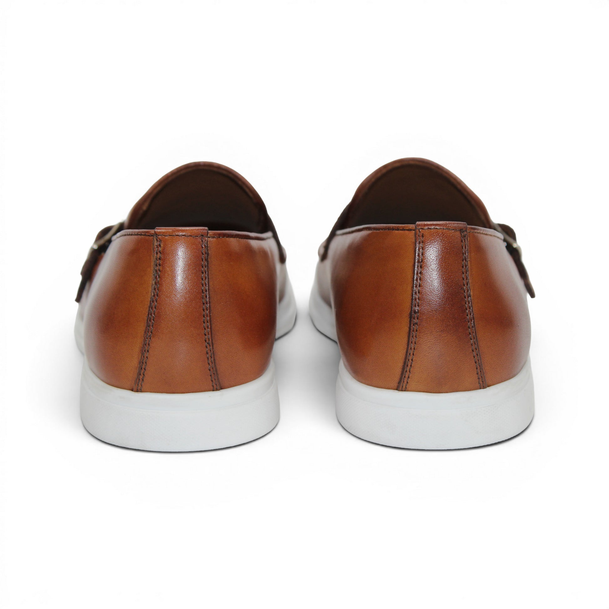 The Duca Di Matiste Duca Rimini Cognac is a brown premium calf leather loafer with metal buckle details and a white rubber sole, showcasing timeless sophistication in its side profile against a plain white background.