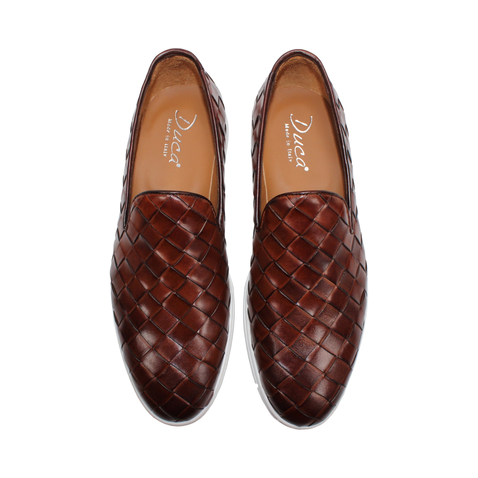 The Duca Di Matiste Duca Rivoli Marrone is a brown woven leather slip-on with a white rubber sole, displayed in side view against a plain white background, highlighting luxury footwear.