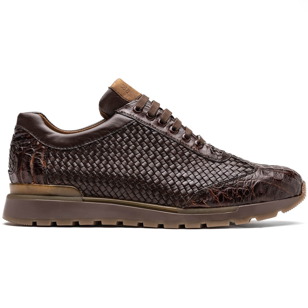 The Marco Di Milano Roma Brown sneakers feature hand-painted textured leather, woven detailing, and rubber soles. One luxury pair stands upright while the other is tilted beneath it.