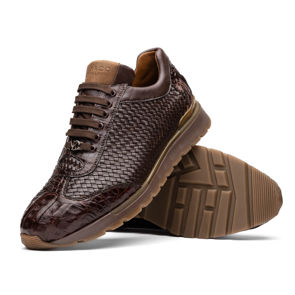 The Marco Di Milano Roma Brown sneakers feature hand-painted textured leather, woven detailing, and rubber soles. One luxury pair stands upright while the other is tilted beneath it.