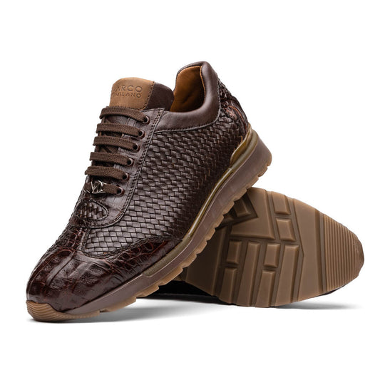 The Marco Di Milano Roma Brown sneakers feature hand-painted textured leather, woven detailing, and rubber soles. One luxury pair stands upright while the other is tilted beneath it.