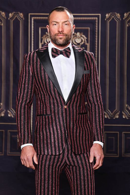 A man wears the MANZINI HEATHER Men's Slim-Fit 2-Piece Glitter Stripe Stage Prom Suit in rose gold by Manzini, posing before an ornate dark backdrop.