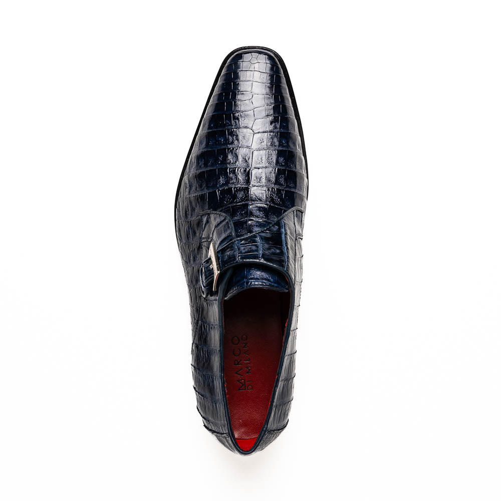 The Marco Di Milano Rovigo Navy features dark blue genuine caiman crocodile monk strap dress shoes with a silver buckle—one upright, the other on its side to display the sole—ideal for luxury men's footwear enthusiasts.