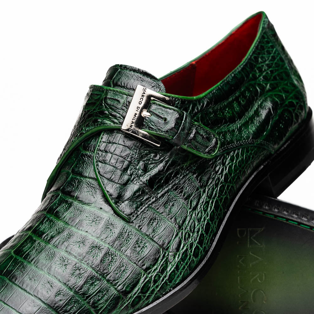 The Marco Di Milano Rovigo Forest Green features genuine caiman crocodile leather and a luxury monk strap, with one dress shoe propped to reveal its sole—a bold statement among men's exotic dress shoes.