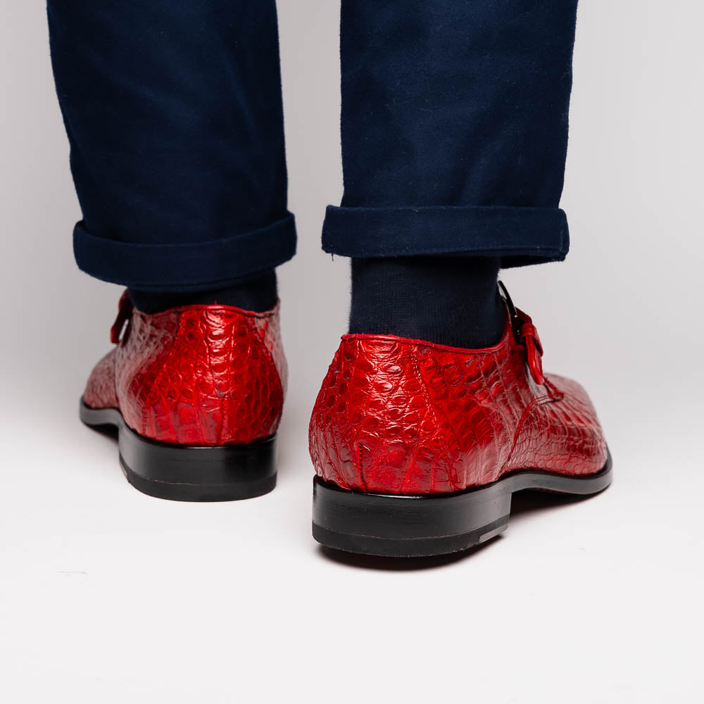 A pair of luxury Marco Di Milano Rovigo Red men's dress shoes in genuine caiman crocodile leather: one upright, the other on its side revealing the elegant sole.