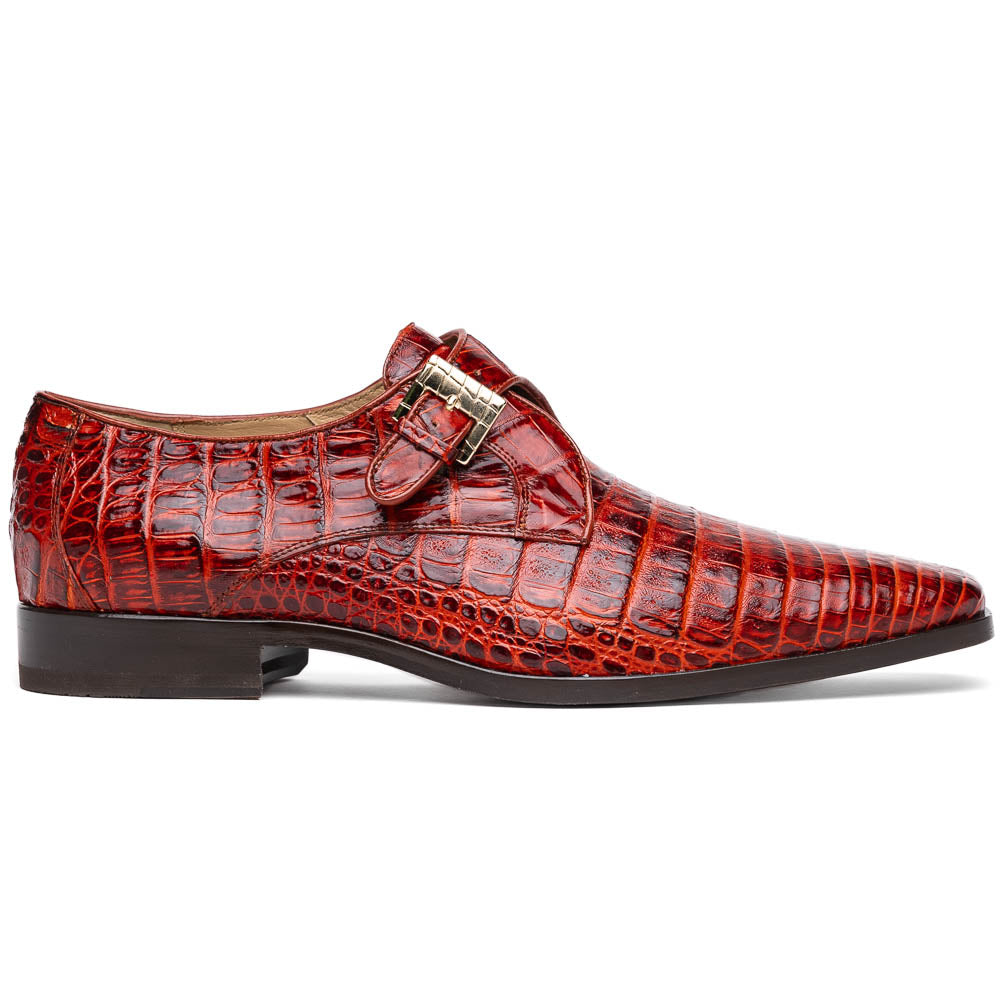A pair of Rovigo Rustic Cognac monk strap dress shoes by Marco Di Milano, featuring shiny genuine caiman crocodile leather with a side buckle; one shoe is upright, and the other lies with its sole facing up.