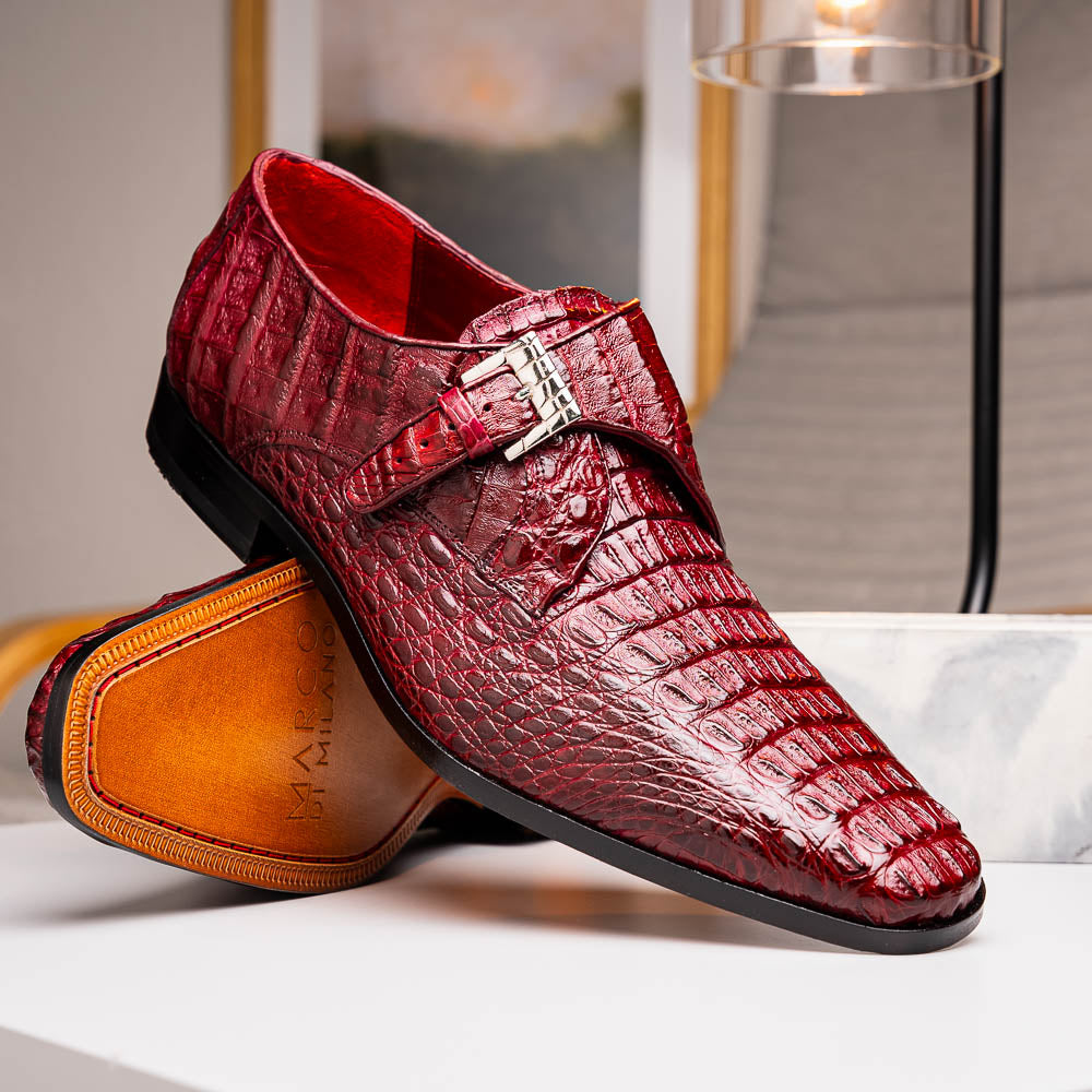 A pair of Luigi Wine monk strap dress shoes by Marco Di Milano, crafted in burgundy crocodile-pattern leather with silver buckles—one shoe displays the sole featuring the Marco Di Milano branding.