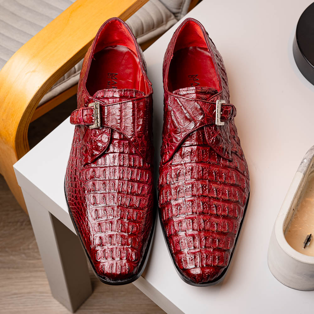 A pair of Luigi Wine monk strap dress shoes by Marco Di Milano, crafted in burgundy crocodile-pattern leather with silver buckles—one shoe displays the sole featuring the Marco Di Milano branding.