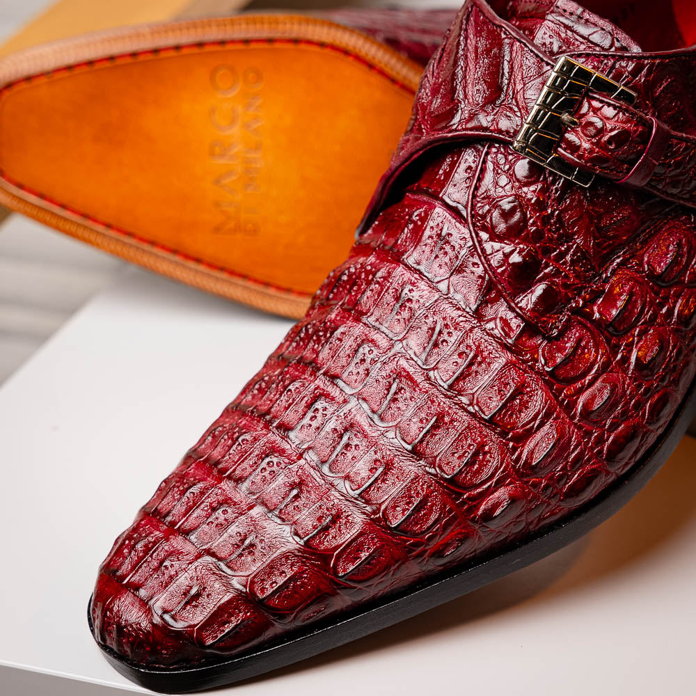 A pair of Luigi Wine monk strap dress shoes by Marco Di Milano, crafted in burgundy crocodile-pattern leather with silver buckles—one shoe displays the sole featuring the Marco Di Milano branding.