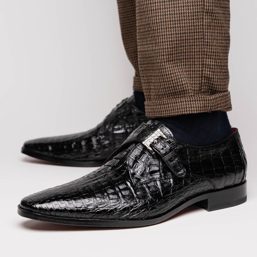 The Marco Di Milano Rovigo Black is a luxury monk strap dress shoe featuring genuine caiman crocodile, a pointed toe, metal buckle, and brown leather sole, displayed on a clean white background.