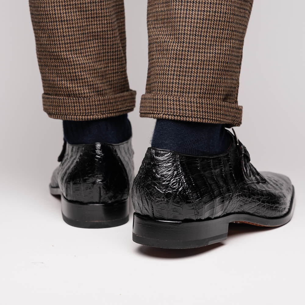 The Marco Di Milano Rovigo Black is a luxury monk strap dress shoe featuring genuine caiman crocodile, a pointed toe, metal buckle, and brown leather sole, displayed on a clean white background.