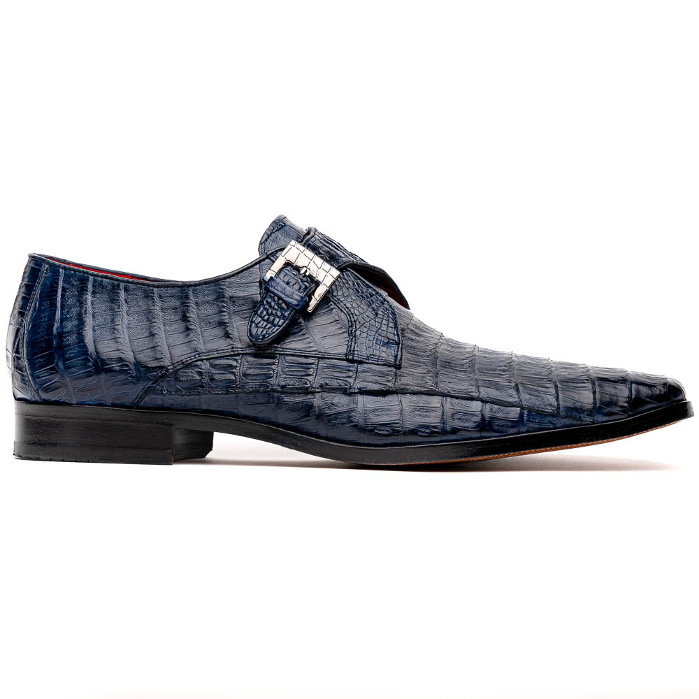 The Marco Di Milano Rovigo B Navy is a luxury men's monk strap shoe in blue crocodile-pattern leather, with one shoe upright and the other showing a tan sole stamped with the brand logo—perfect for dress shoe aficionados.