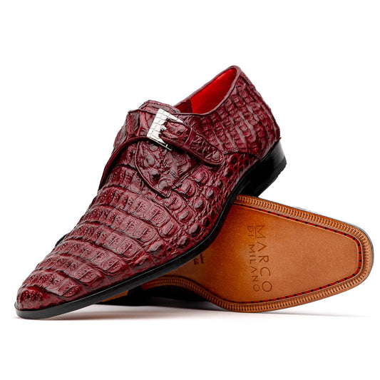 A pair of Luigi Wine monk strap dress shoes by Marco Di Milano, crafted in burgundy crocodile-pattern leather with silver buckles—one shoe displays the sole featuring the Marco Di Milano branding.