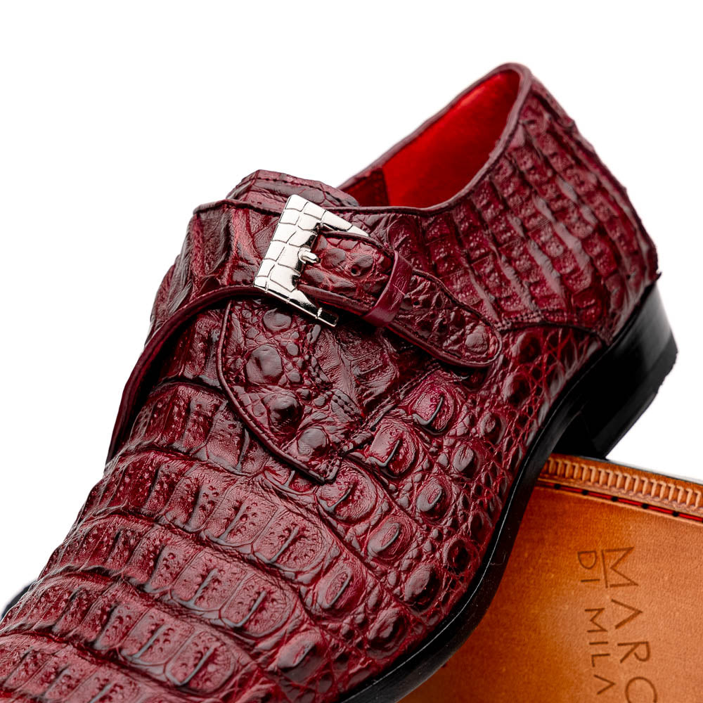 A pair of Luigi Wine monk strap dress shoes by Marco Di Milano, crafted in burgundy crocodile-pattern leather with silver buckles—one shoe displays the sole featuring the Marco Di Milano branding.