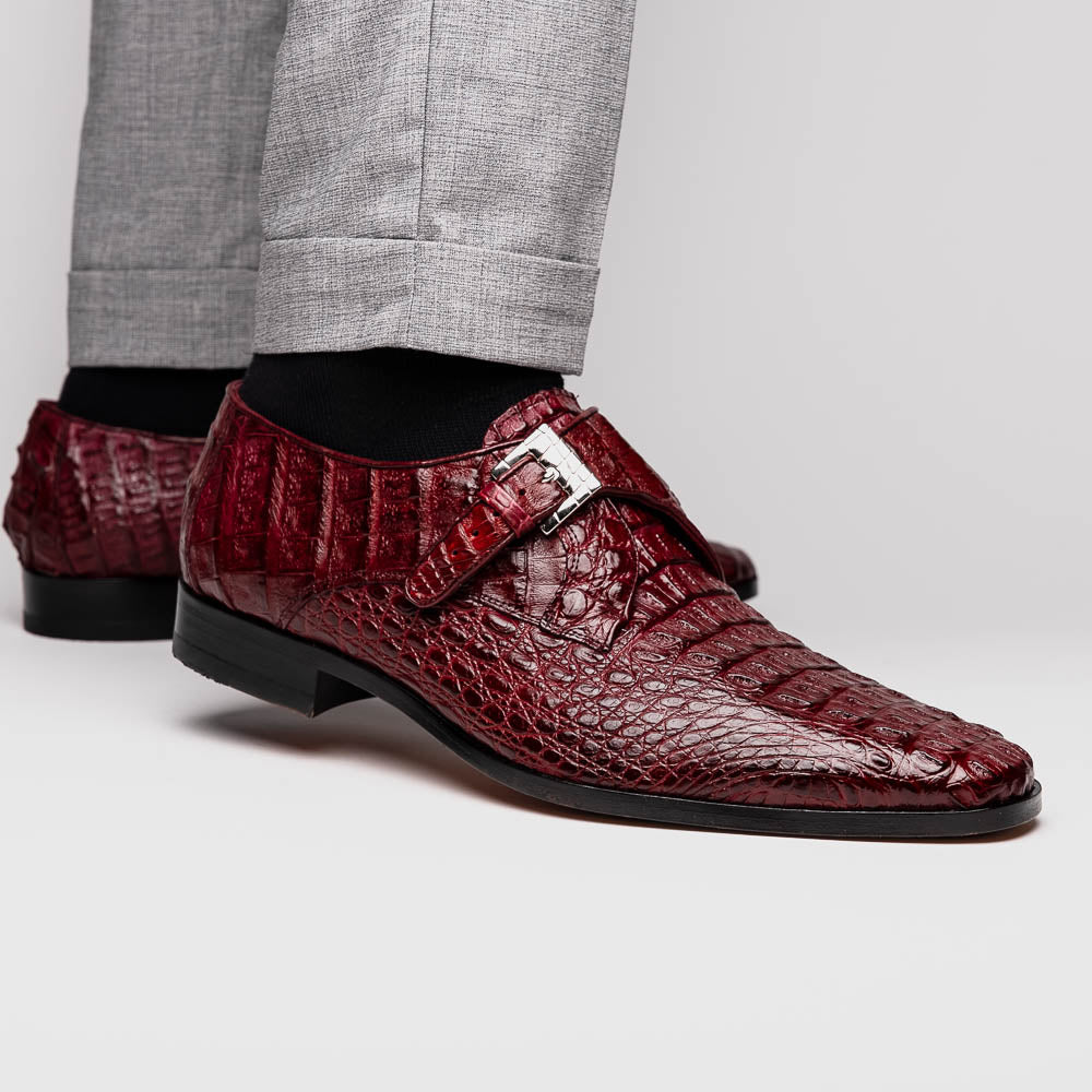 A pair of Luigi Wine monk strap dress shoes by Marco Di Milano, crafted in burgundy crocodile-pattern leather with silver buckles—one shoe displays the sole featuring the Marco Di Milano branding.