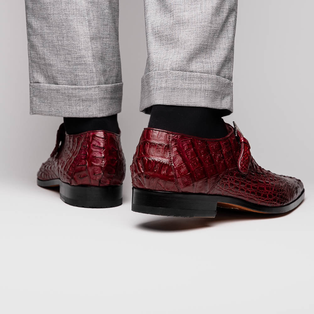 A pair of Luigi Wine monk strap dress shoes by Marco Di Milano, crafted in burgundy crocodile-pattern leather with silver buckles—one shoe displays the sole featuring the Marco Di Milano branding.
