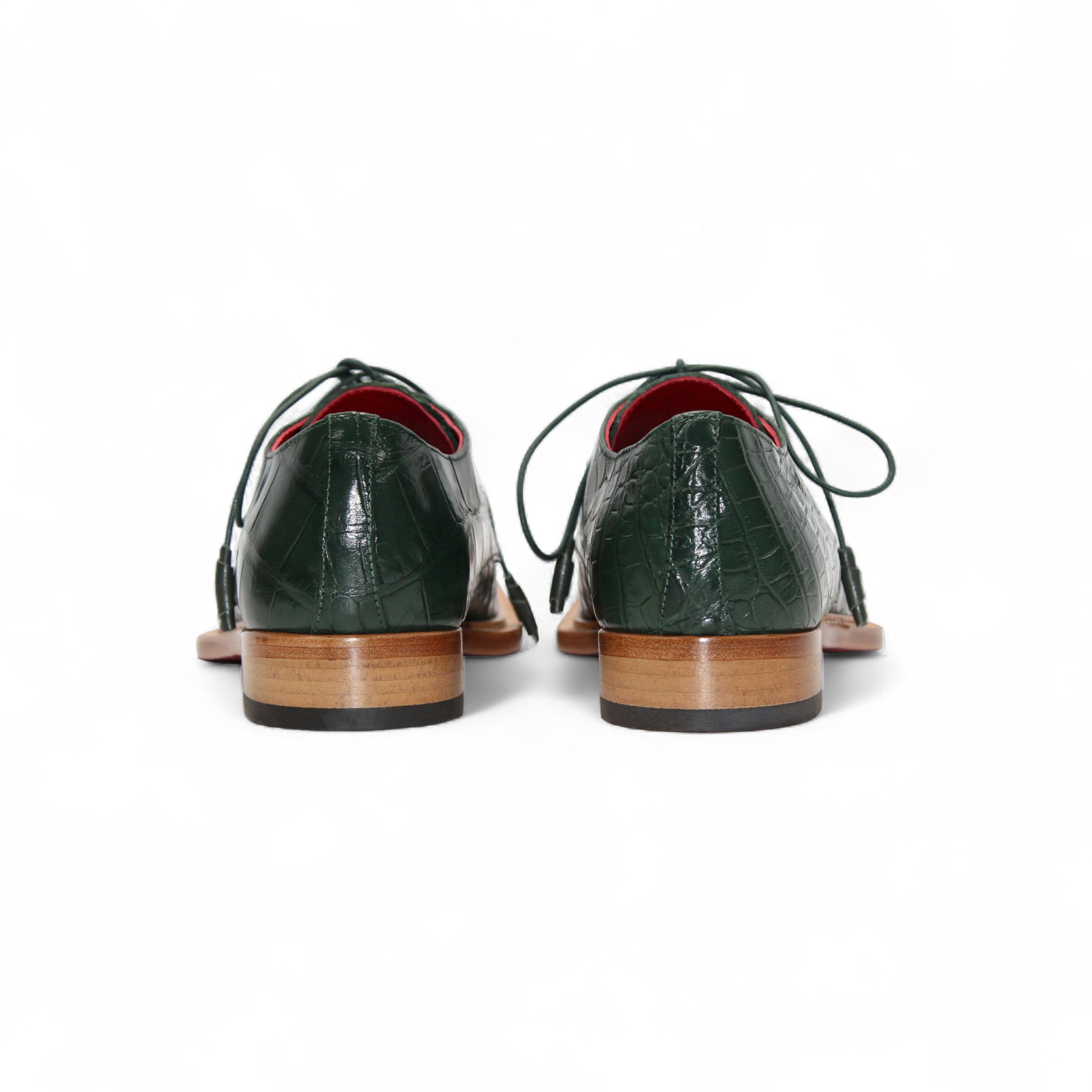 The Fennix Rowan Green by Fennix of Italy is a dark green, crocodile-patterned leather dress shoe with laces, brown sole, and low heel, crafted in Italy and shown from the side on a white background.