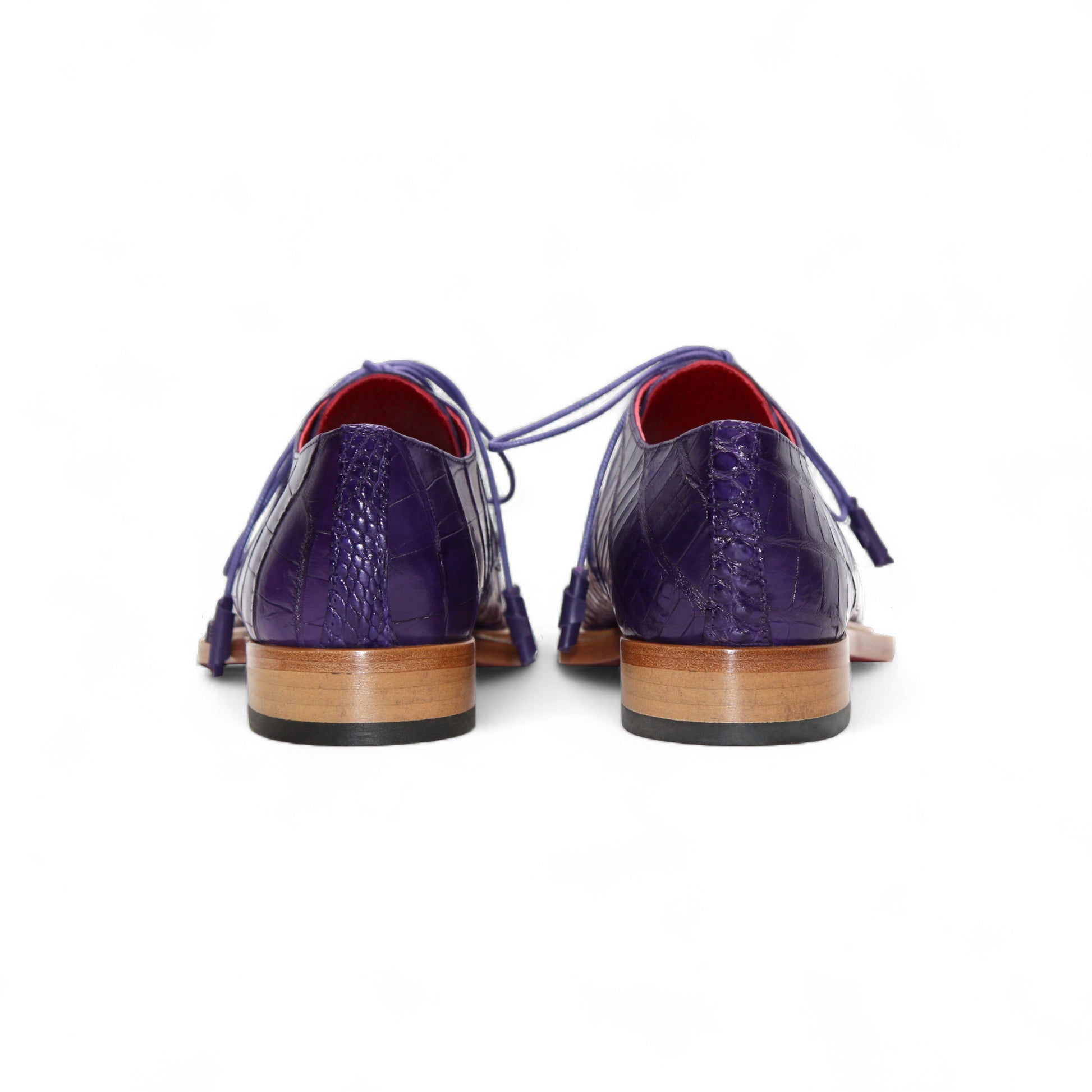 The Fennix Rowan Purple by Fennix of Italy is a luxury purple lace-up dress shoe made from genuine alligator leather, featuring Italian craftsmanship, a brown sole, and a red interior. It's displayed in profile against a white background.